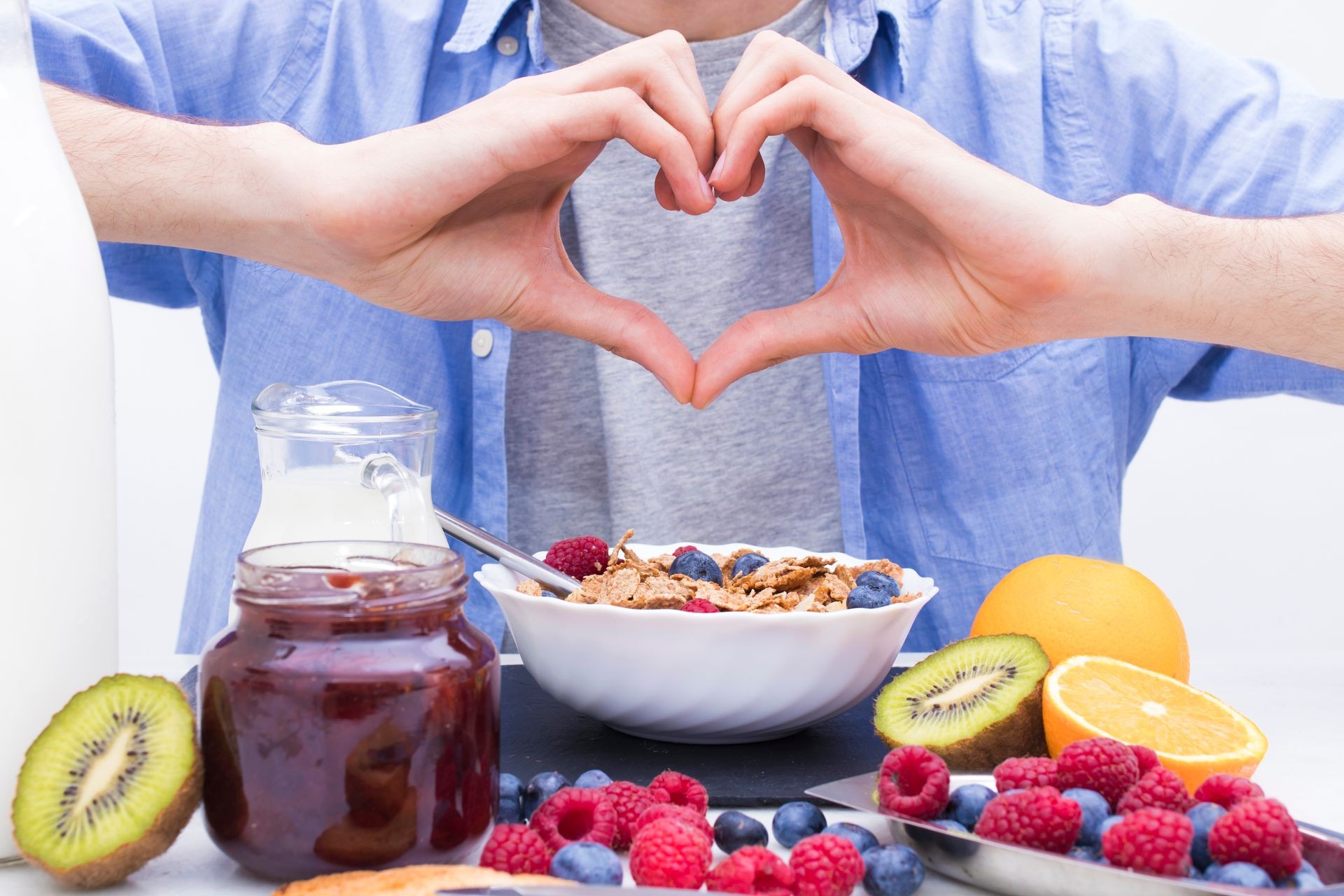 heart-shaped hands with breakfast and healthy food